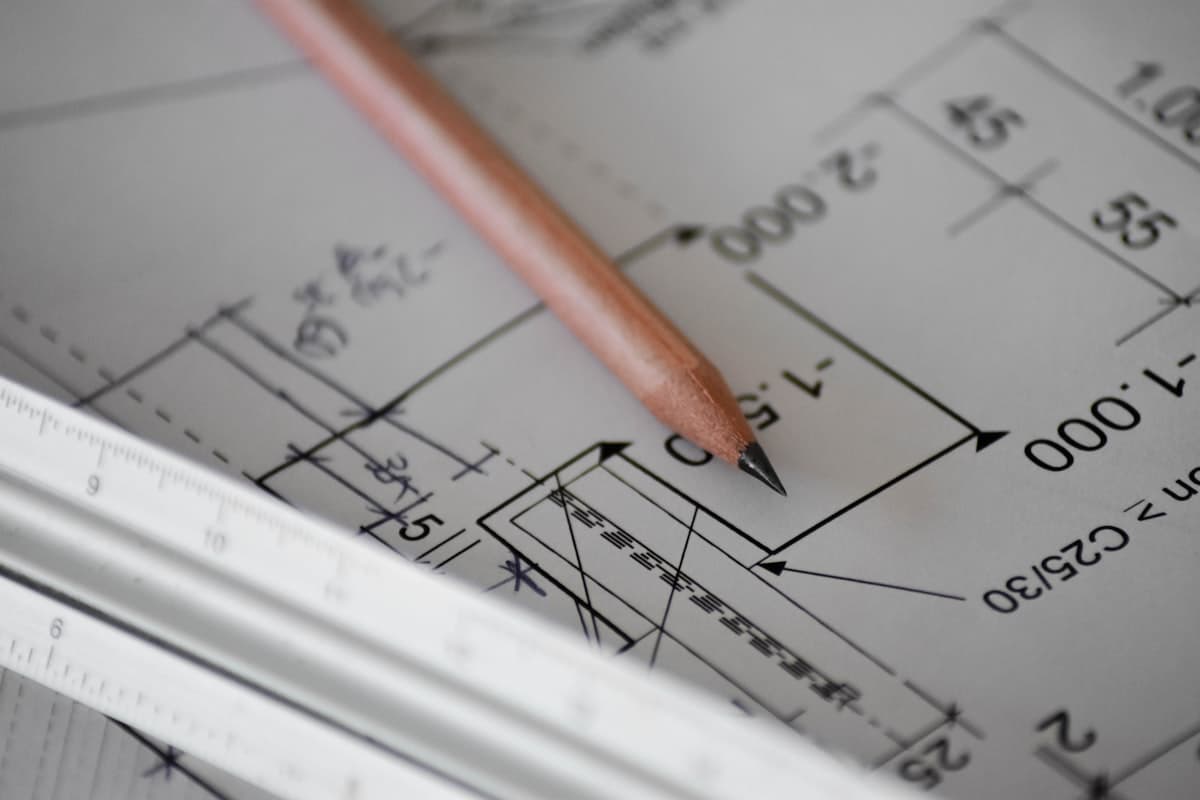 Engineer reviewing technical blueprints